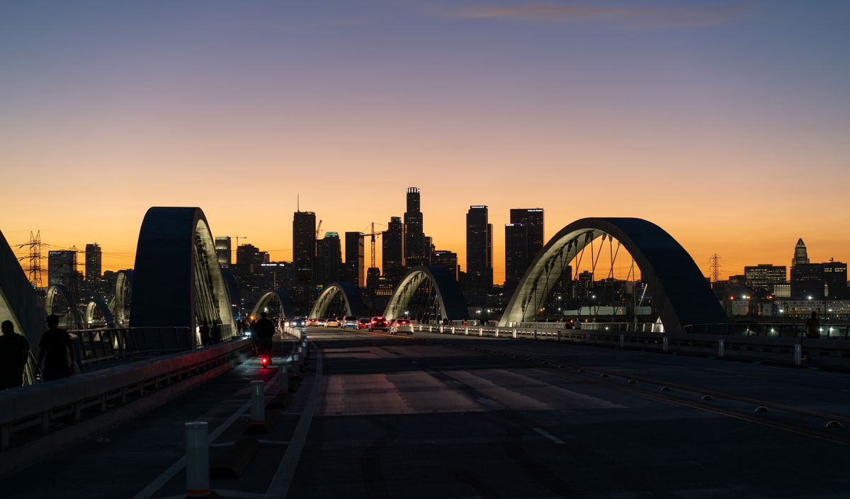General views of the 6th Street Viaduct bridge against the Downtown Los Angeles skyline.