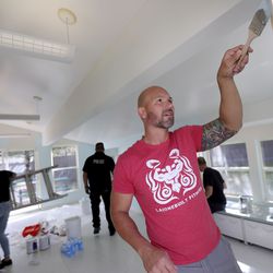 Unified Police Sgt. Luis Lovato paints a playroom at the LifeStart Village, a self-sufficiency housing program for homeless single-parent families, in Midvale on Wednesday, June 17, 2020.