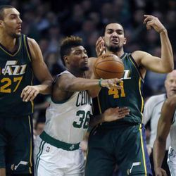 Boston Celtics' Marcus Smart (36) and Utah Jazz's Trey Lyles (41) battle for a loose ball during the second quarter of an NBA basketball game in Boston, Monday, Feb. 29, 2016. (AP Photo/Michael Dwyer)