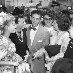 Fans surround crooner Frank Sinatra as he arrives in Pasadena, Calif., Aug. 11, 1943, for Hollywood film and singing engagements.