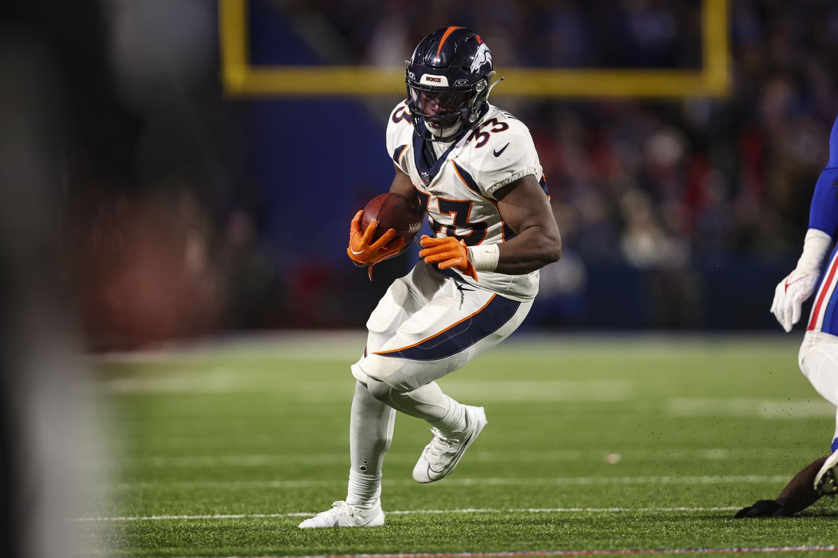 Javonte Williams #33 of the Denver Broncos runs the ball during an NFL football game against the Buffalo Bills at Highmark Stadium on November 13, 2023 in Orchard Park, New York.