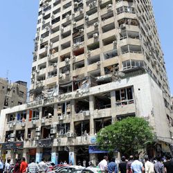This photo released by the Syrian official news agency SANA, shows a damaged commercial  building after a powerful explosion occurred in the central district of Marjeh, in Damascus, Syria, Tuesday April 30, 2013. A powerful explosion rocked Damascus on Tuesday, causing scores of casualties, a day after the country's prime minister narrowly escaped an assassination attempt in the heart of the heavily protected capital. 