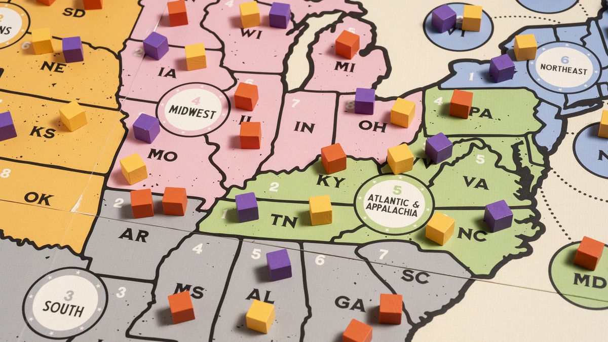 A colorful gameboard representing the eastern half of the U.S. filled with yellow, orange, and purple markers. From Votes for Women, the board game.