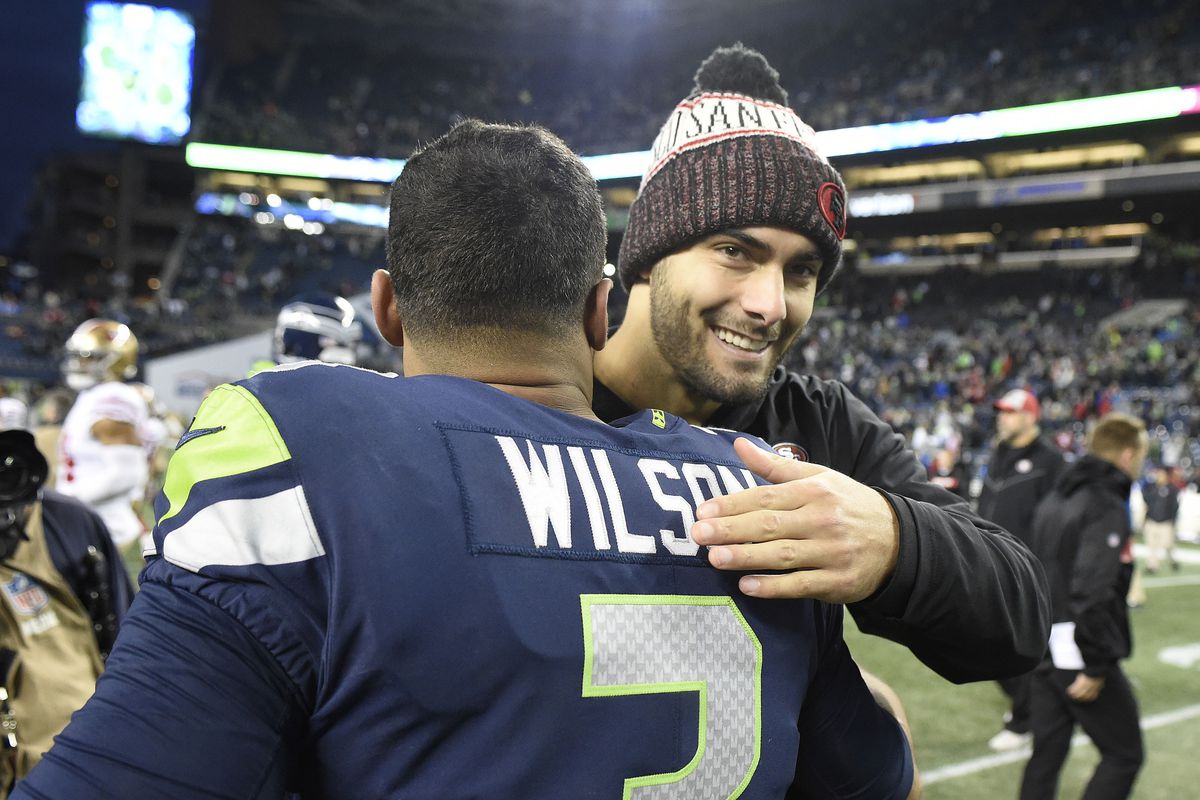 Seattle Seahawks quarterback Russell Wilson meets San Francisco 49ers quarterback Jimmy Garoppolo after a football game at CenturyLink Field.