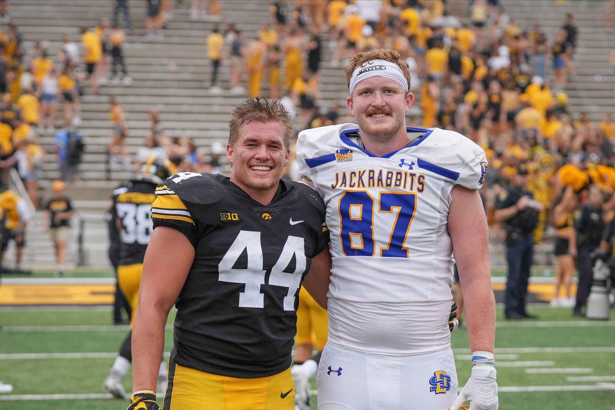 Iowa senior linebacker Seth Benson, left, poses for a photo with South Dakota State senior tight end Zach Heins after Iowa’s 7-3 win over the Jackrabbits during a NCAA football game on Saturday, Sept. 3, 2022, at Kinnick Stadium in Iowa City.