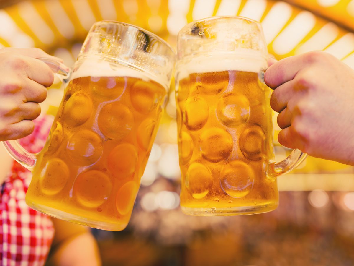 A stock photo of two beer steins clinking