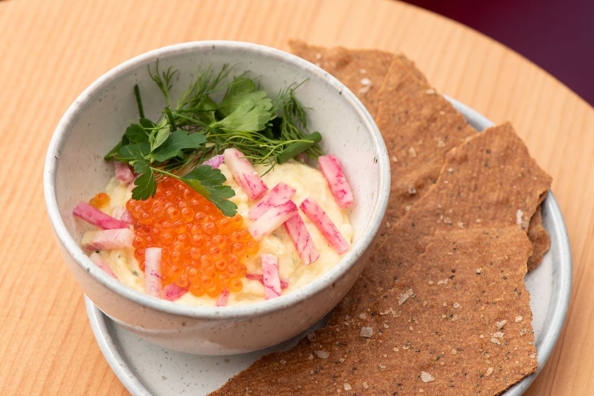 A bowl of roe with crisps on the side to dip.