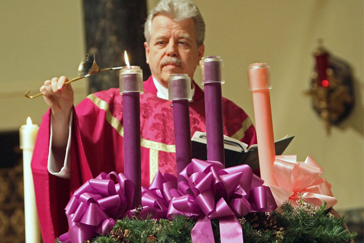 The Rev. Joseph Schlafer lights the first candle in an Advent wreath at St. Joseph Church in Garden City, N.Y.