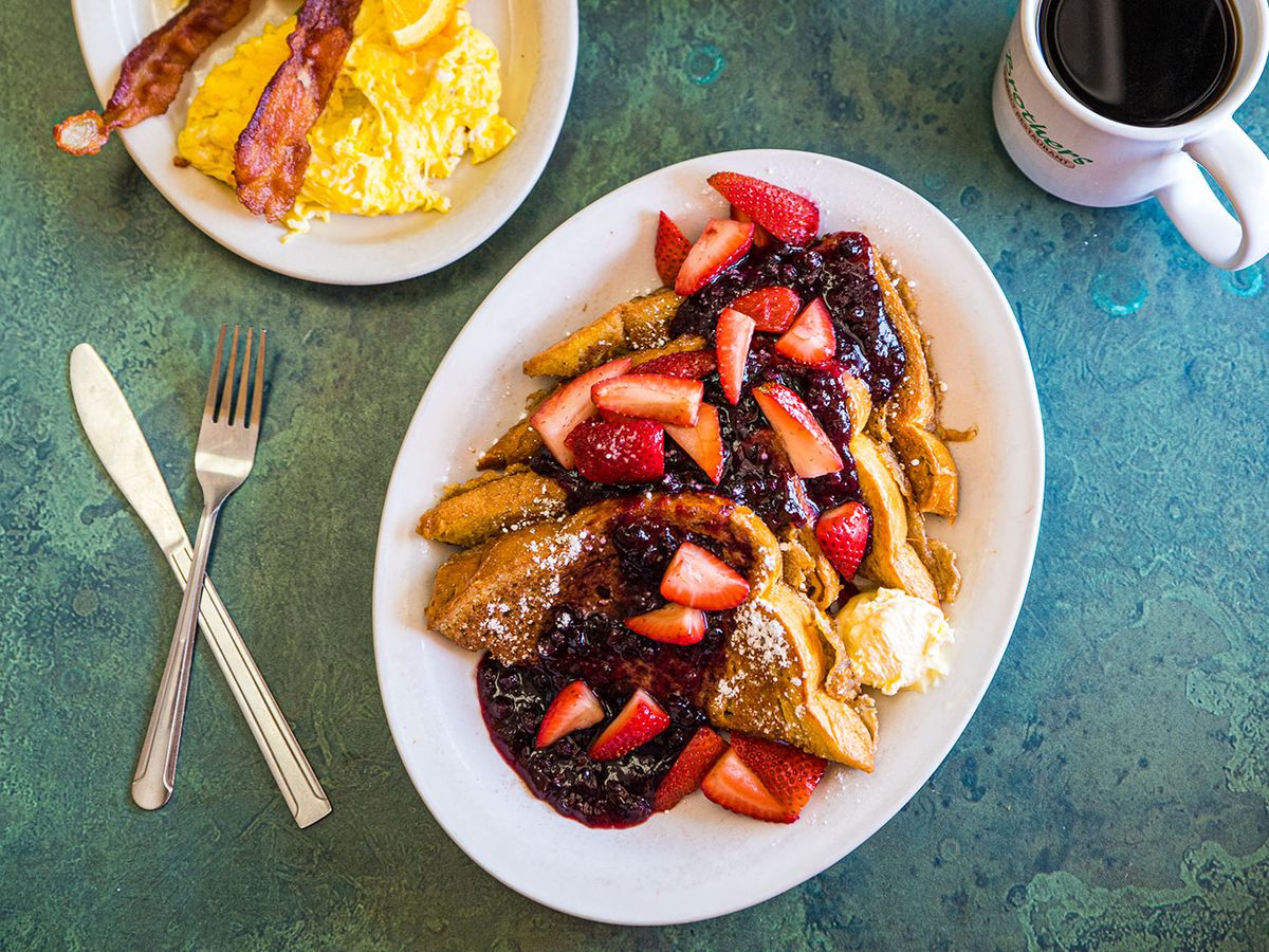 A plate of French toast topped with berries.