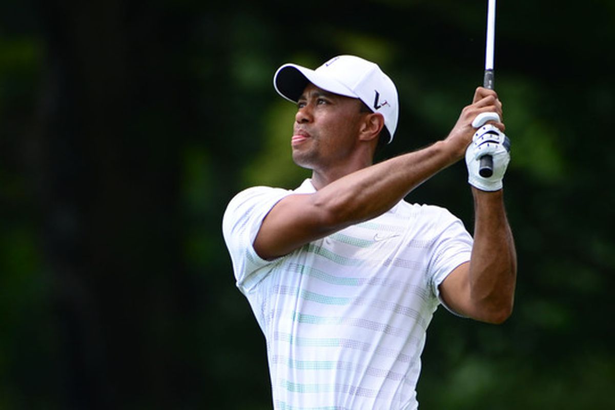 Jul 5, 2012, White Sulphur Springs, WV, USA; Tiger Woods hits from the fairway on the 17th hole during the first round of the Greenbrier Classic at the The Old White TPC. Mandatory Credit: Bob Donnan-US PRESSWIRE