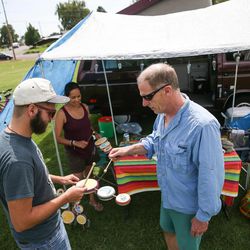 Alex Gennett, of Salt Lake City, plays an eclipse-inspired drum beat with Jane and John Hayden, of Edmonds, Wash., as they await Monday's solar eclipse in Weiser, Idaho, on Sunday, Aug. 20, 2017.