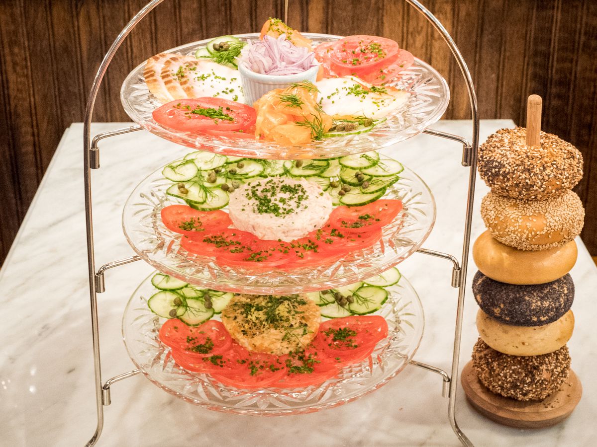 A tower with smoked salmon next to a tower of bagels