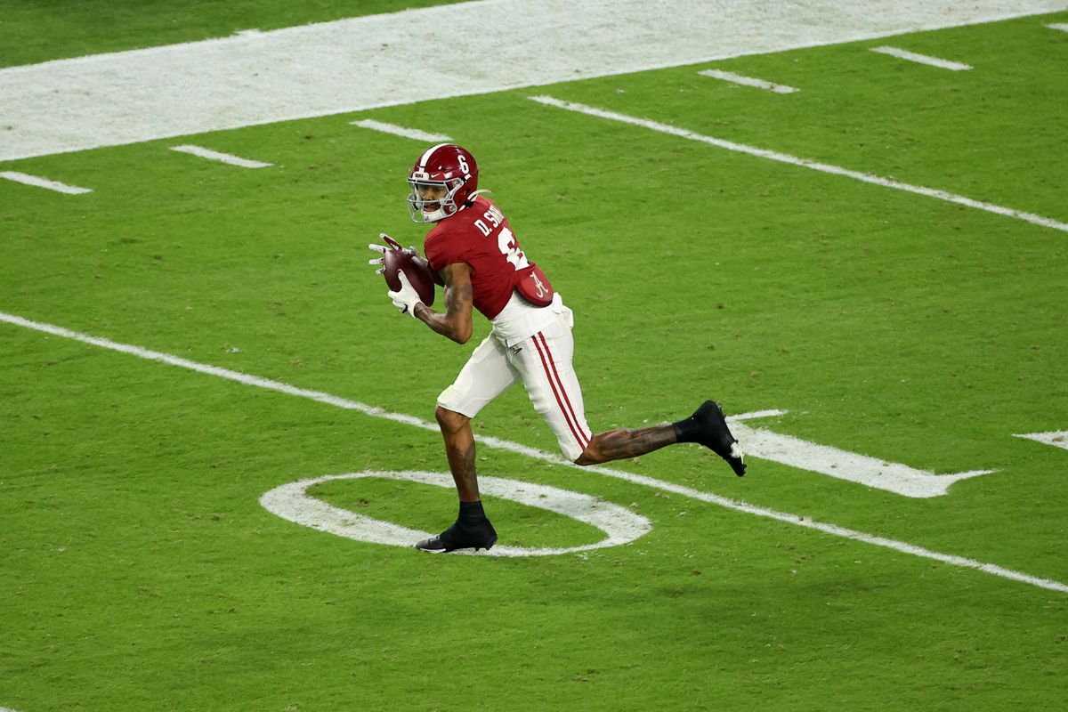 DeVonta Smith of the Alabama Crimson Tide pulls in a pass against the Ohio State Buckeyes during the College Football Playoff National Championship held at Hard Rock Stadium on January 11, 2021 in Miami Gardens, Florida.