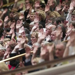 Members of the audience take part in the sustaining vote during the afternoon session Saturday, April 6, 2013 of the 183th Annual General Conference of The Church of Jesus Christ of Latter-day Saints in the Conference Center.