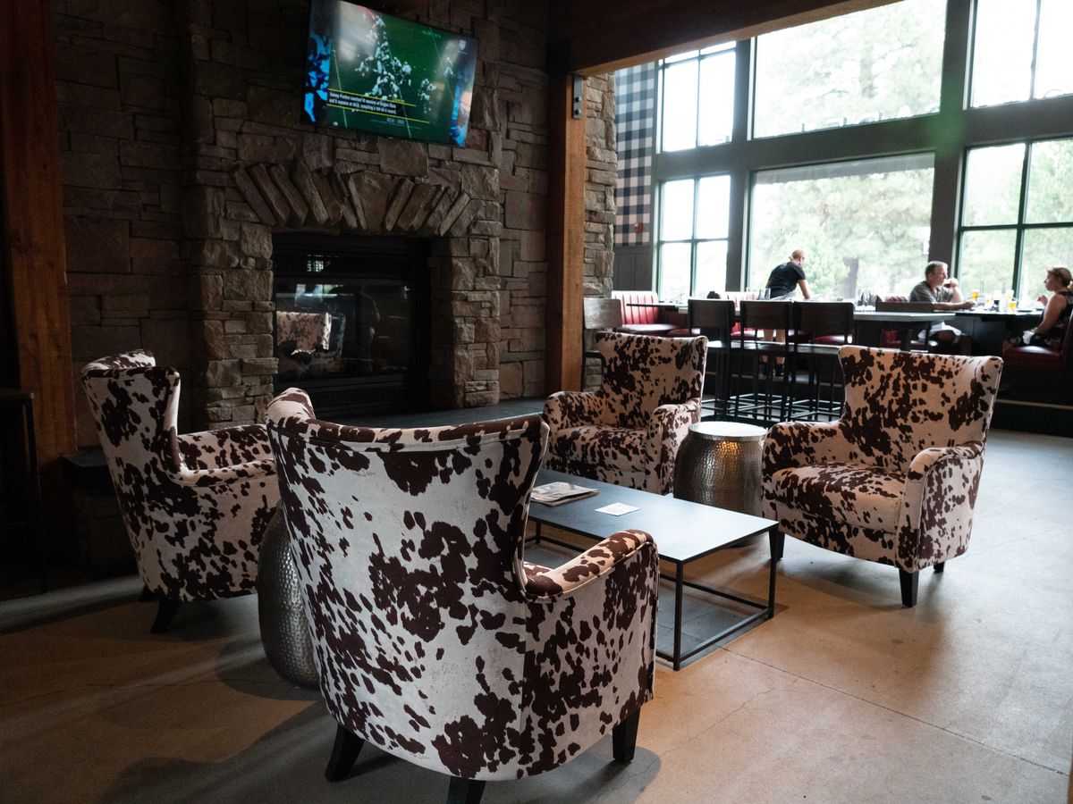 Cowhide chairs near fireplace at Cascade Lakes Brewpub.