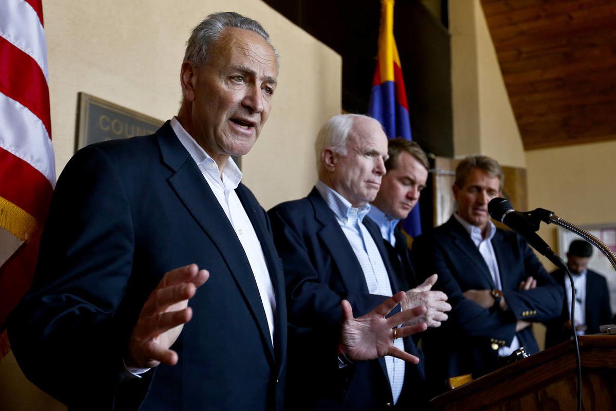 Sen. Chuck Schumer, D-N.Y., left, speaks to the media as, from second left, Sen. John McCain, R-Ariz., Sen. Michael Bennett, D-Colo., and Sen. Jeff Flake, R-Ariz., listen in during a news conference after their tour of the Mexico border with the United St