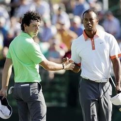 Rory McIlroy, left, of Northern Ireland, and Tiger Woods shake hands on the 18th green during practice for the U.S. Open golf tournament at Merion Golf Club, Wednesday, June 12, 2013, in Ardmore, Pa. (AP Photo/Charlie Riedel)