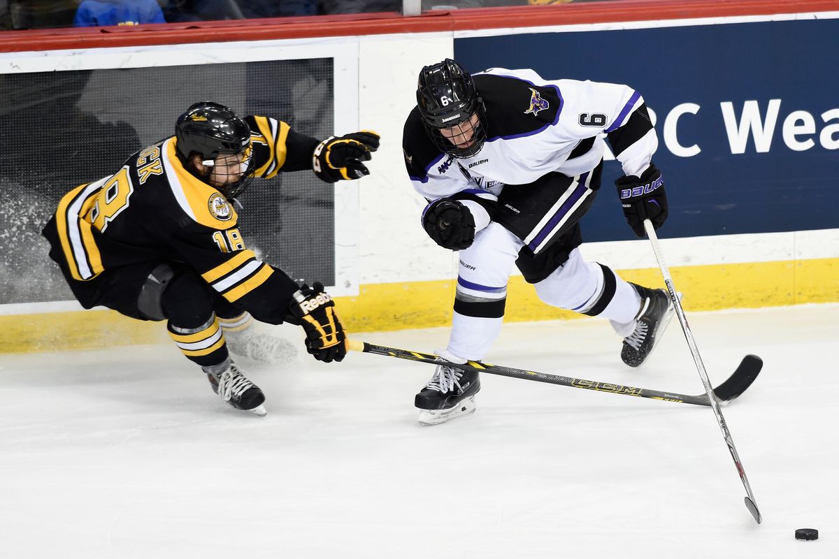 Casey Nelson #6 of Minnesota State controls the puck against CJ Eick #18 of Michigan Tech