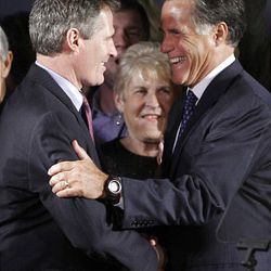 Scott Brown, left, celebrates with Mitt Romney on Tuesday.   