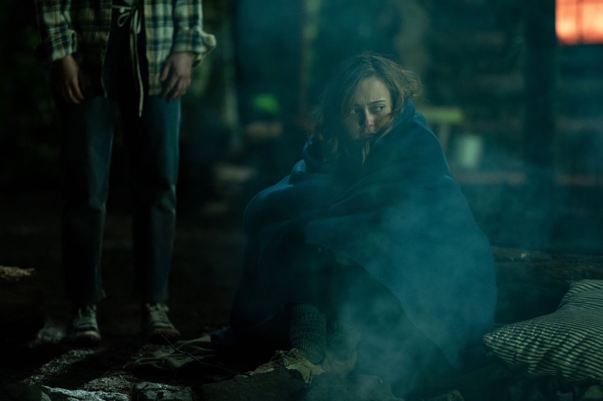 Jackie sulking near a firepit in a still from the final episode of season 1 of Yellowjackets