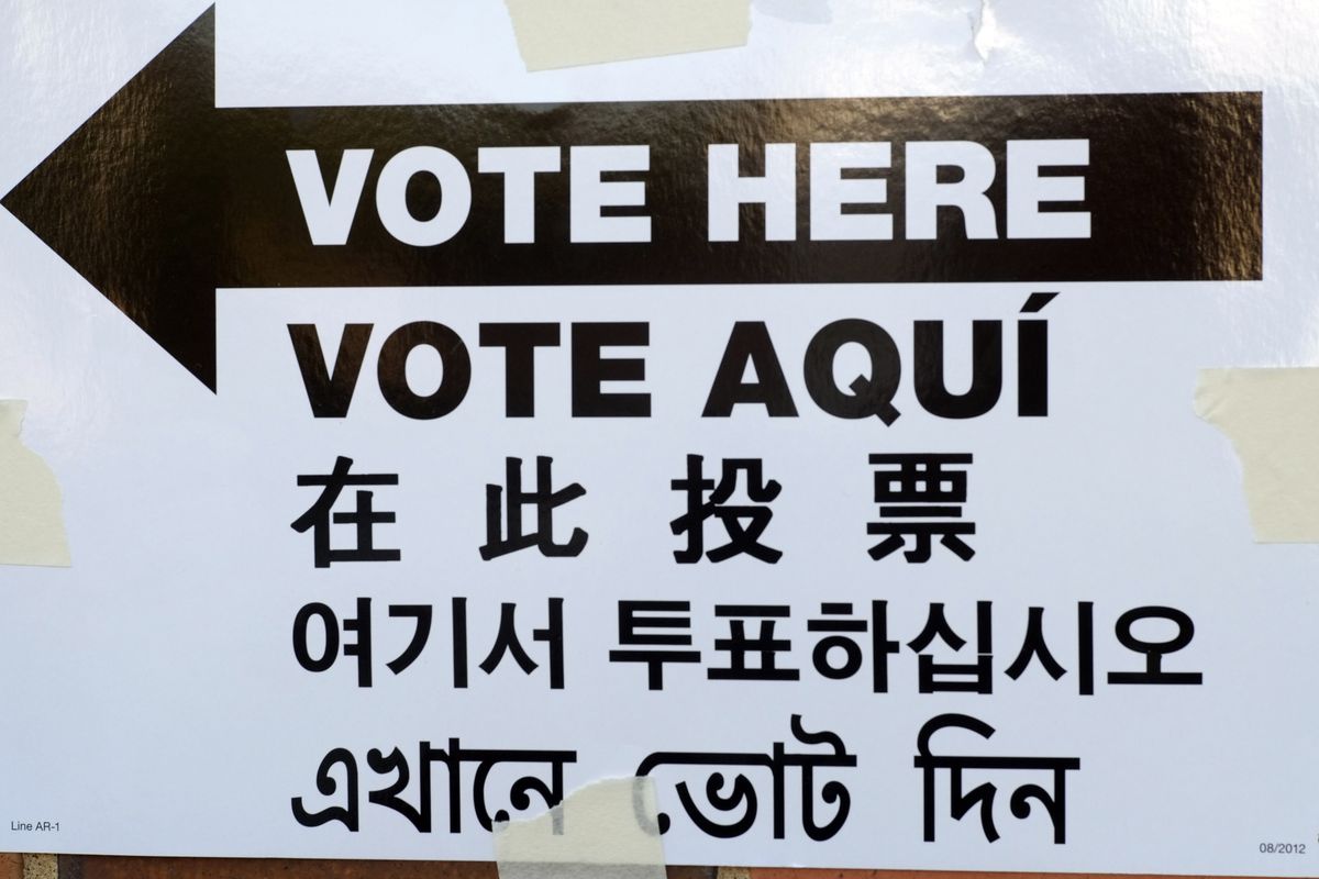 A “Vote Here” sign is posted outside an election site in Brooklyn, in English, Spanish, Chinese, Korean and Bengali. 