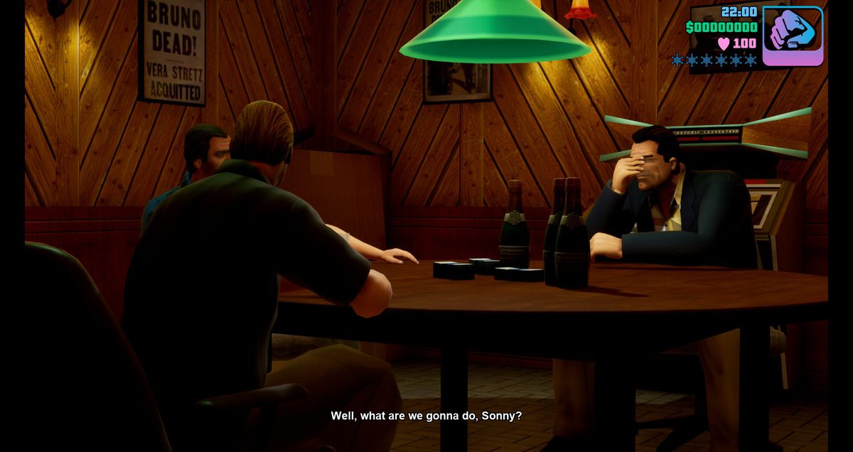 Members of a criminal syndicate sit around a table in a poorly lit room in the GTA Trilogy.