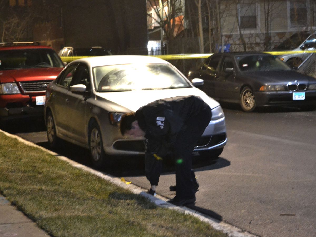Police investigate the shooting of a 18-year-old man Friday evening in the 7400 block of South Colfax. | Justin Jackson/Sun-Times