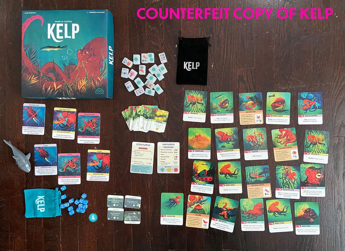 A collection of cards, dice, and mahjong tiles from a counterfeit version of Kelp, a new board game.