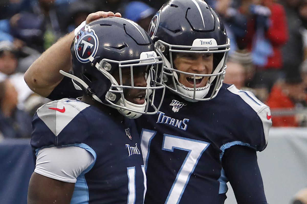 Quarterback Ryan Tannehill of the Tennessee Titans reacts with his teammate wide receiver A.J. Brown of the Tennessee Titans after a touchdown during the first quarter in the game against the New Orleans Saints at Nissan Stadium on December 22, 2019 in Nashville, Tennessee.