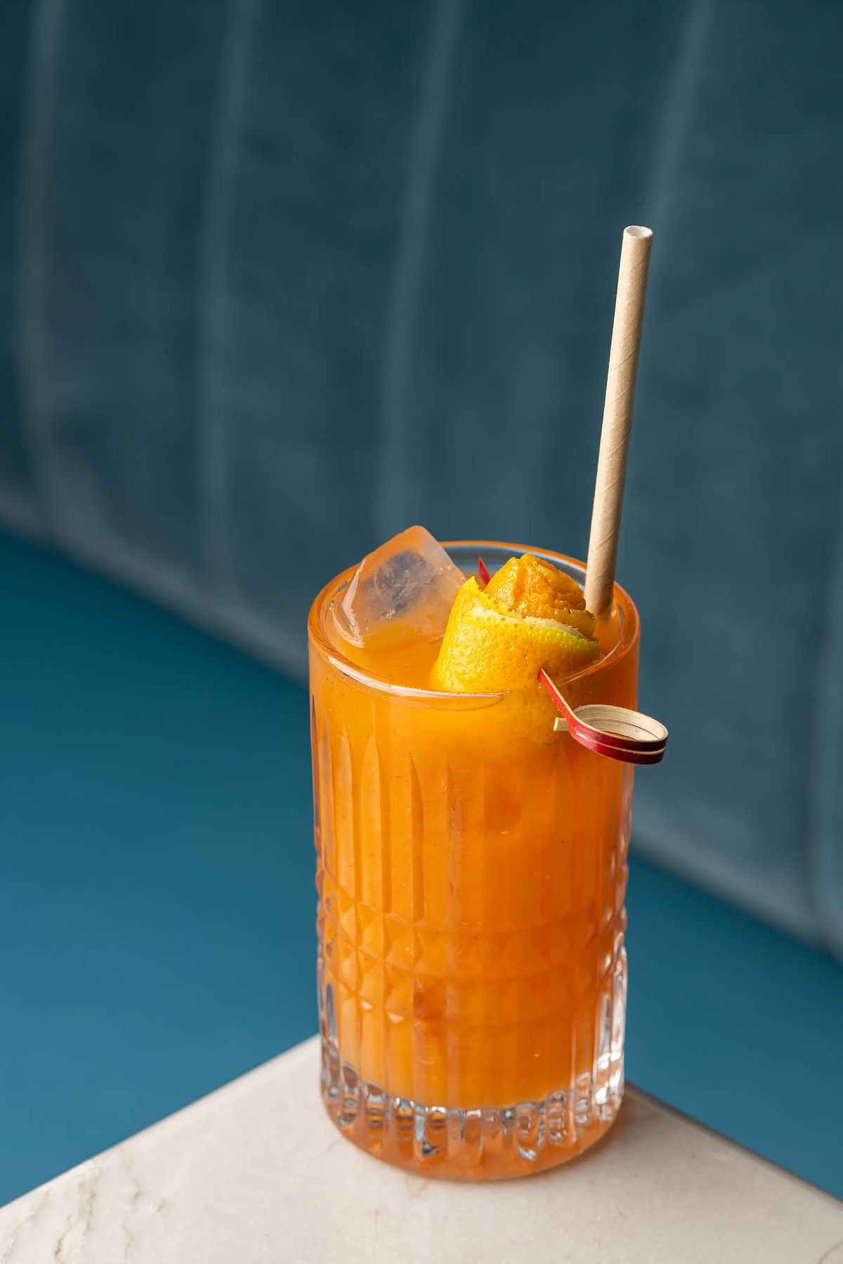 The orange Hera Pheri cocktail with mezcal, orange liqueur, spicy guava chutney, and pink salt at Baar Baar.