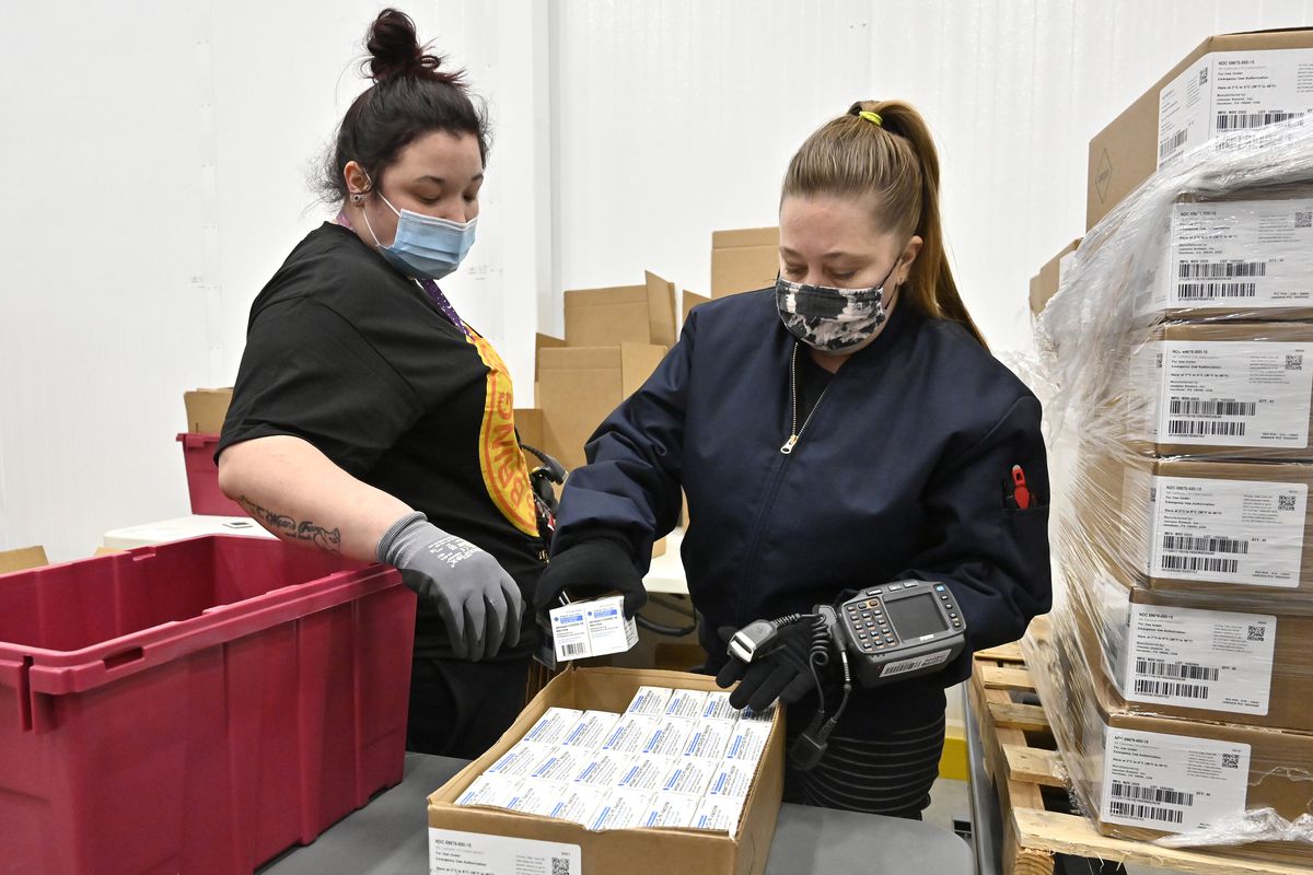 An employee with the McKesson Corporation scans a box of the Johnson &amp; Johnson Covid-19 vaccine as she fills an order at their shipping facility on March 1, 2021, in Shepherdsville, Kentucky.