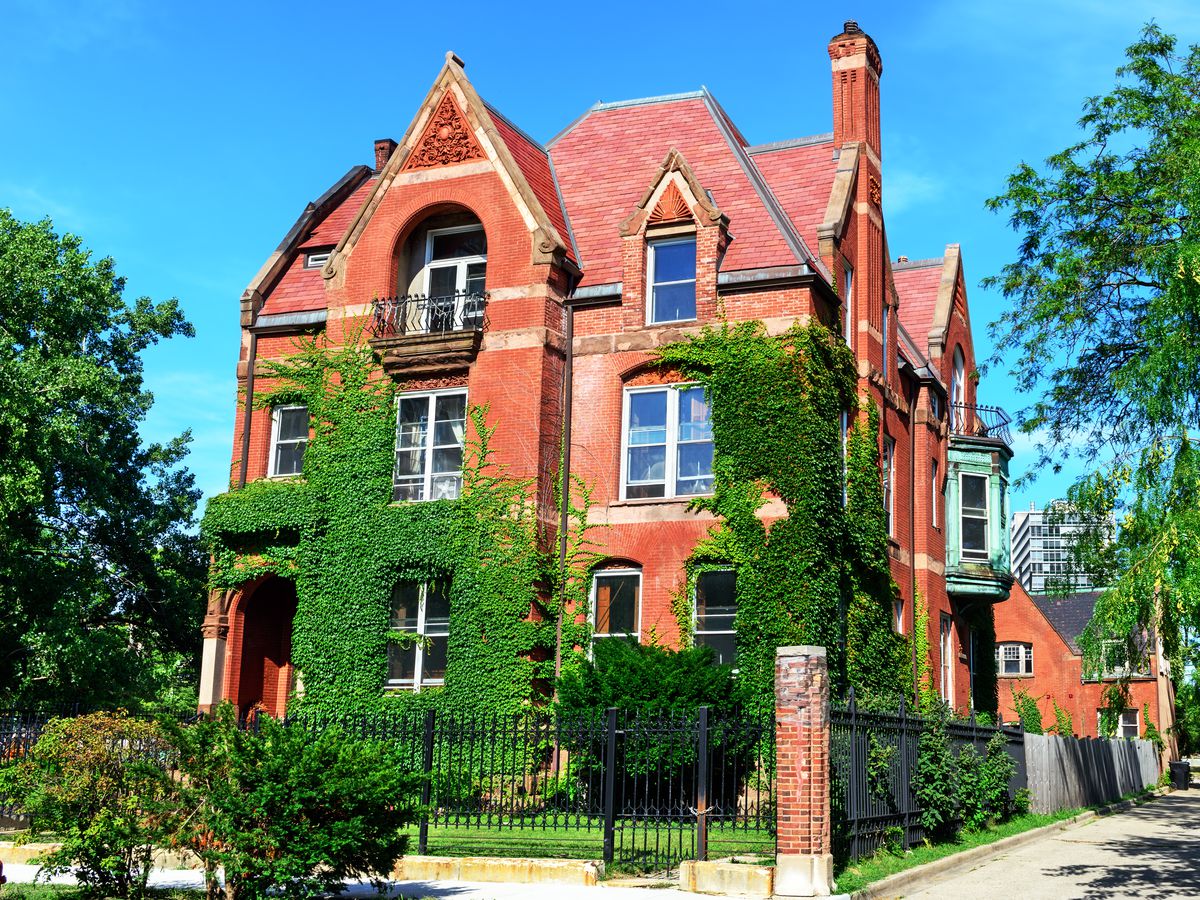 The exterior of the Wood Maxey Body House in Chicago. The facade is red brick and there is green ivy on some of the walls. 
