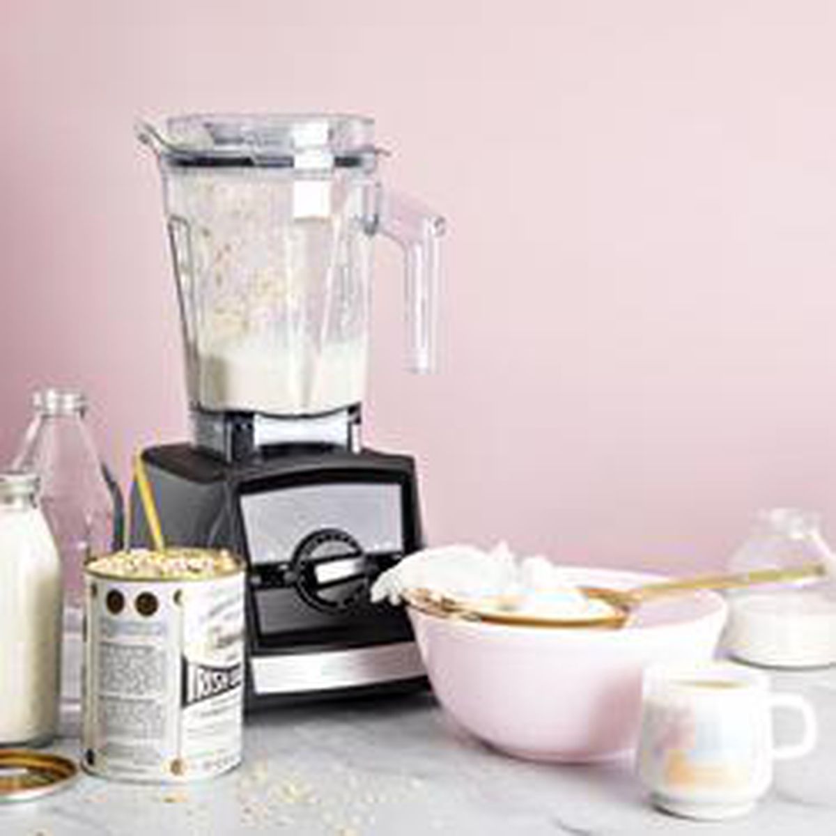 A vitamix blender surrounded by baking supplies