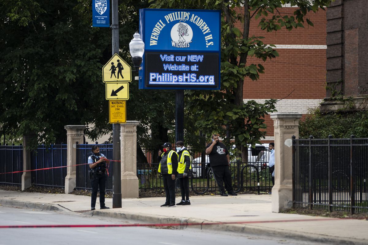 Chicago police investigate after a 14-year-old girl and a security guard were both shot Tuesday afternoon outside Wendell Phillips Academy High School in the 3800 block of South Giles in Bronzeville.