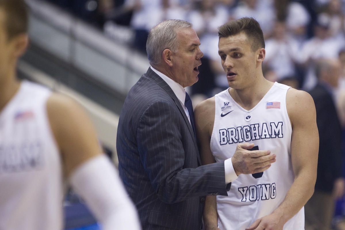 Brigham Young Cougars head coach Dave Rose congratulates Brigham Young Cougars guard Kyle Collinsworth (5) as he walks off the floor for the last time after recording his NCAA career record 11th triple-double in the second half of action at the Marriott C