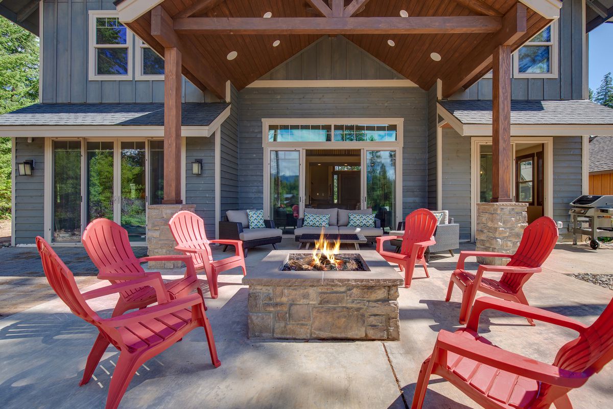 Red chairs around fire pit on back patio
