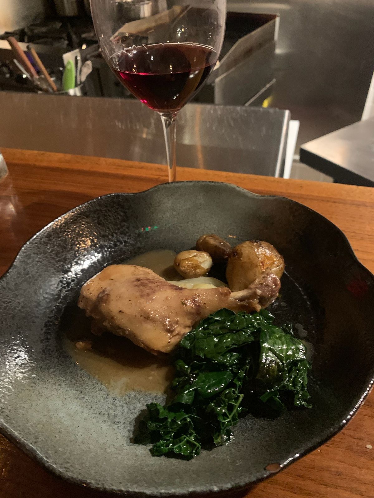 Braised duck leg with sauteed kale at Mr. Pollo.
