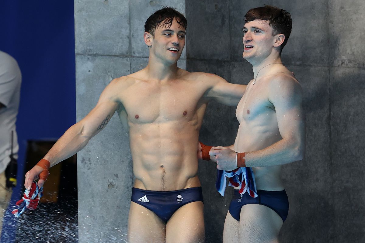 Tom Daley, left, and Matty Lee react to winning the gold in the 10-meter men’s platform diving at the Tokyo Olympics.