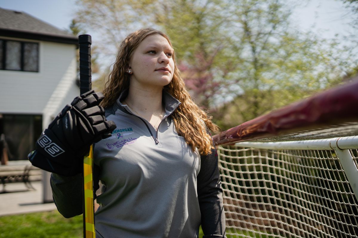 Despite being able to rejoin the team, Morgan said from then on she was “super uncomfortable” being alone with her coach and other players’ parents. Morgan poses with hockey stick in hand in front of a goal in her backyard. 