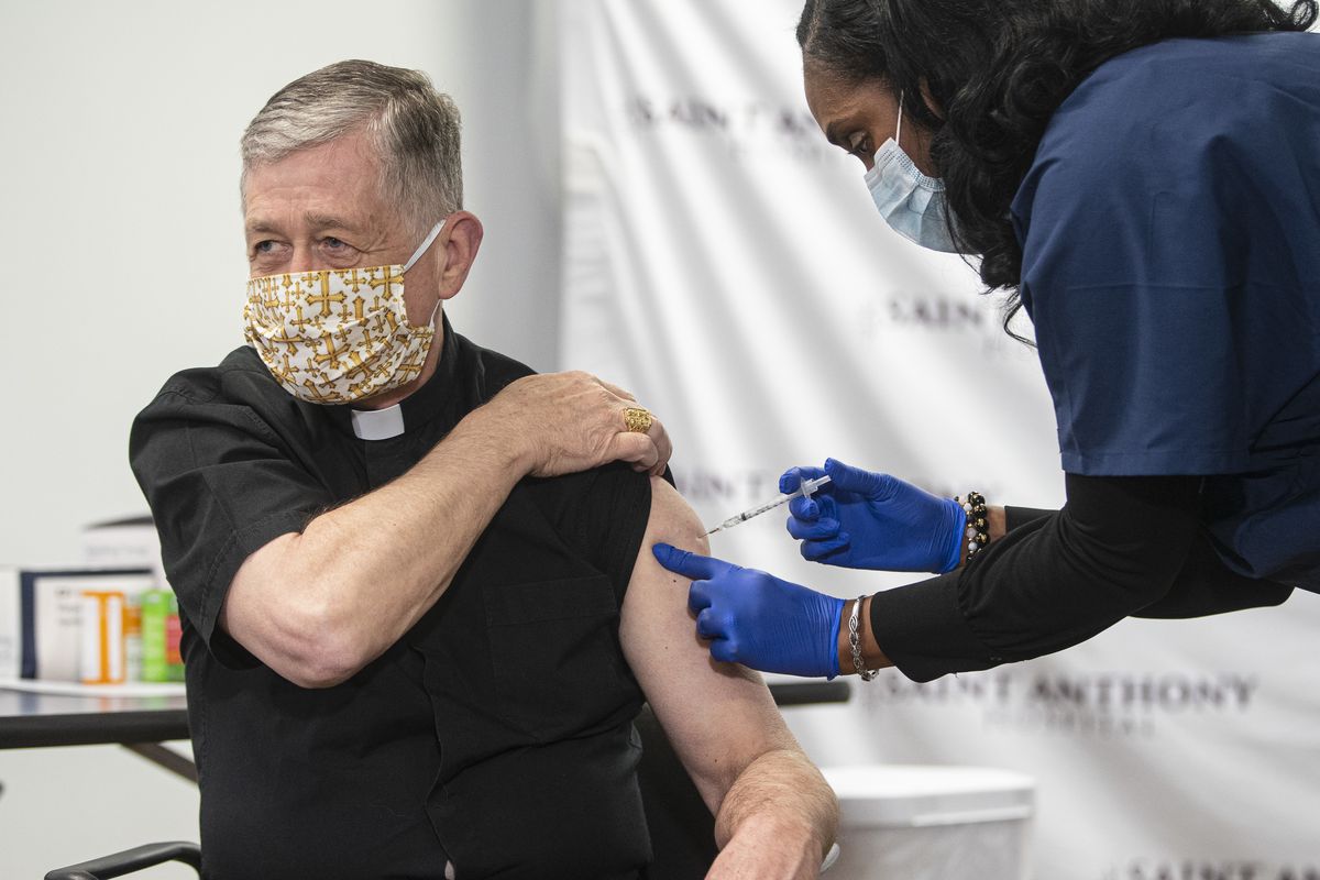 Cardinal Blase Cupich receives a coronavirus vaccination Wednesday at Saint Anthony Hospital.