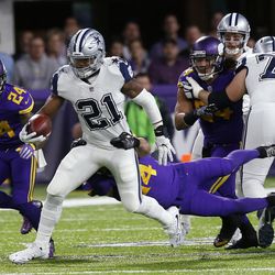 Dallas Cowboys running back Ezekiel Elliott (21) tries to break a tackle by Minnesota Vikings strong safety Andrew Sendejo during the first half of an NFL football game Thursday, Dec. 1, 2016, in Minneapolis. 