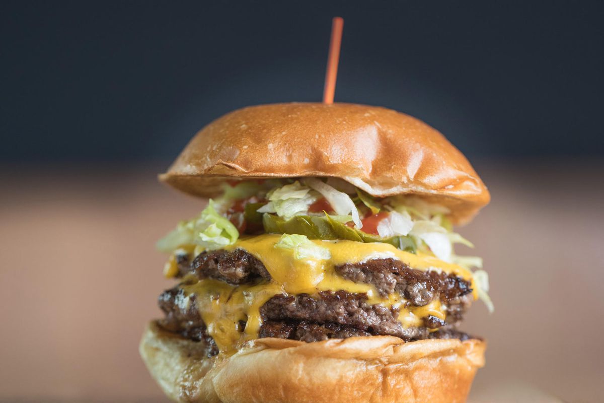 A close up of a double cheeseburger.