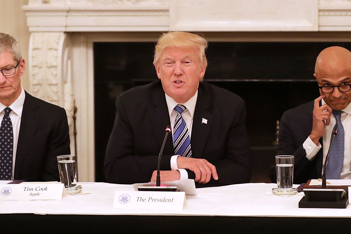 President Trump is seated between Apple CEO Tim Cook and Microsoft CEO Satya Nadella.