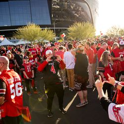 Chris Done takes a photo of Cori Davis as Utah fans congregate outside Allegiant Stadium in Las Vegas before the Utes face the Oregon Ducks in the Pac-12 championship game on Friday, Dec. 3, 2021.