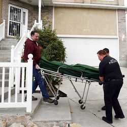 A body is carried out of a Sandy home today where a stabbing occurred.