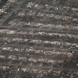 This aerial photo shows the remains of homes hit by a massive tornado in Moore, Okla., Monday May 20, 2013. A tornado roared through the Oklahoma City suburbs Monday, flattening entire neighborhoods, setting buildings on fire and landing a direct blow on an elementary school. 