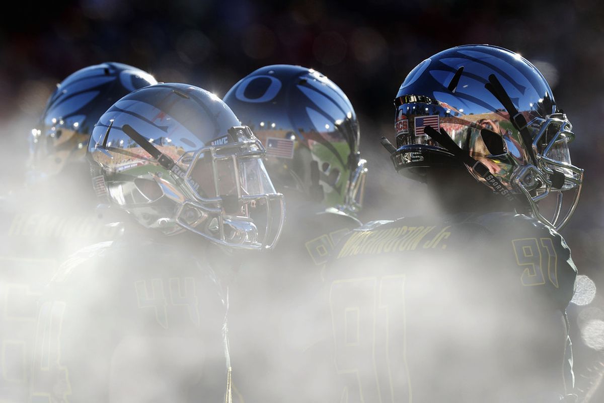 PASADENA, CA - JANUARY 02: Oregon Ducks players stand in front of the misters on the sideline as the Ducks take on the Wisconsin Badgers at the 98th Rose Bowl Game on January 2, 2012 in Pasadena, California.  (Photo by Harry How/Getty Images)