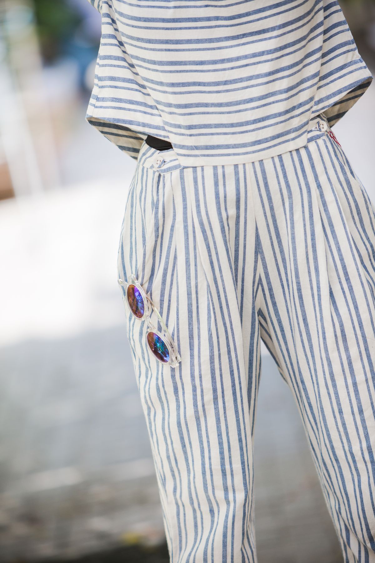 A detail of the striped jumpsuit
