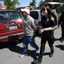 Salt Lake police officers Jeff Perea and Tiffany Commagere arrest Luis Alberto MonguÍ Bautista in connection with drug distribution in Salt Lake City Tuesday, May 4, 2010.
