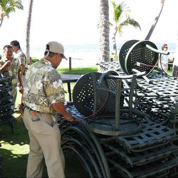 Workers at the Marriott Maui Ocean Club resort in Lahaina, Hawaii, tie down chairs before a tsunami was predicted to hit Hawaii Saturday.